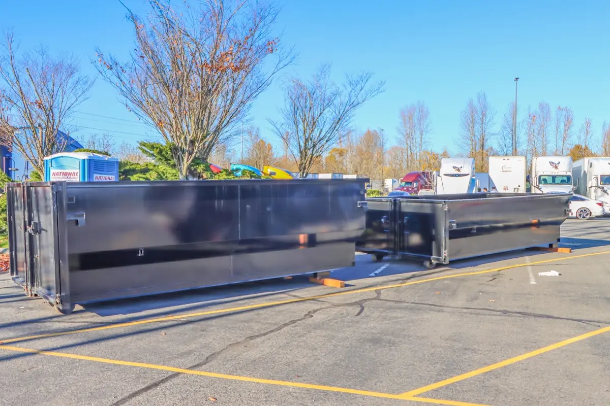 Professional dumpster rental service with roll-off container on residential driveway in Okmulgee